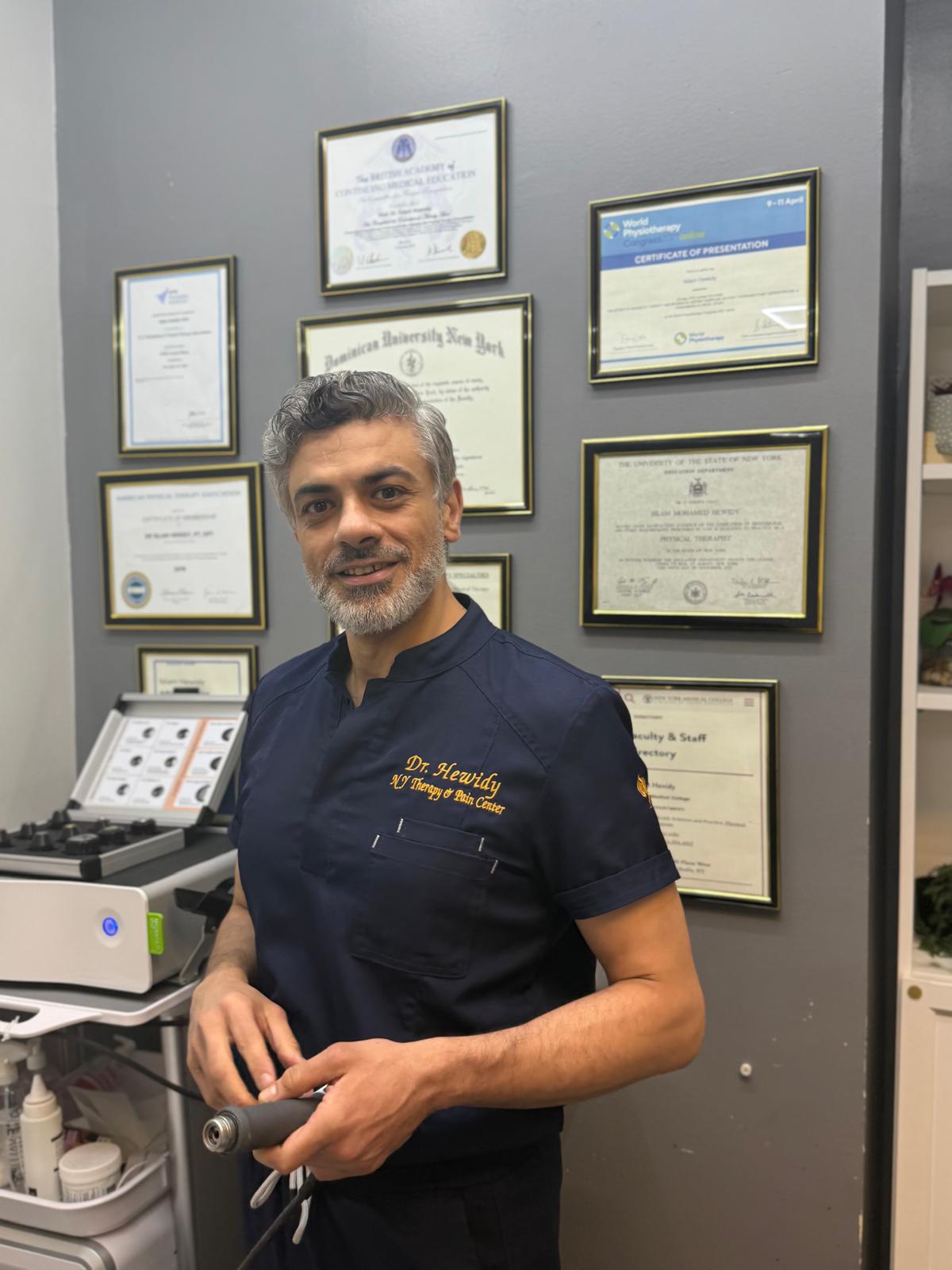 Dr. Sam Hewidy smiling in the clinic